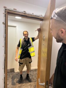 Vanguard engineers checking a newly hung fire door in its frame