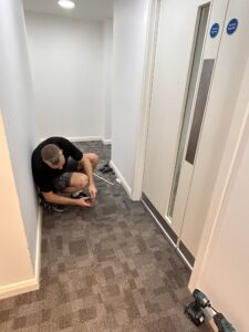 Vanguard engineer inspecting the base of a communal fire door at Central Park